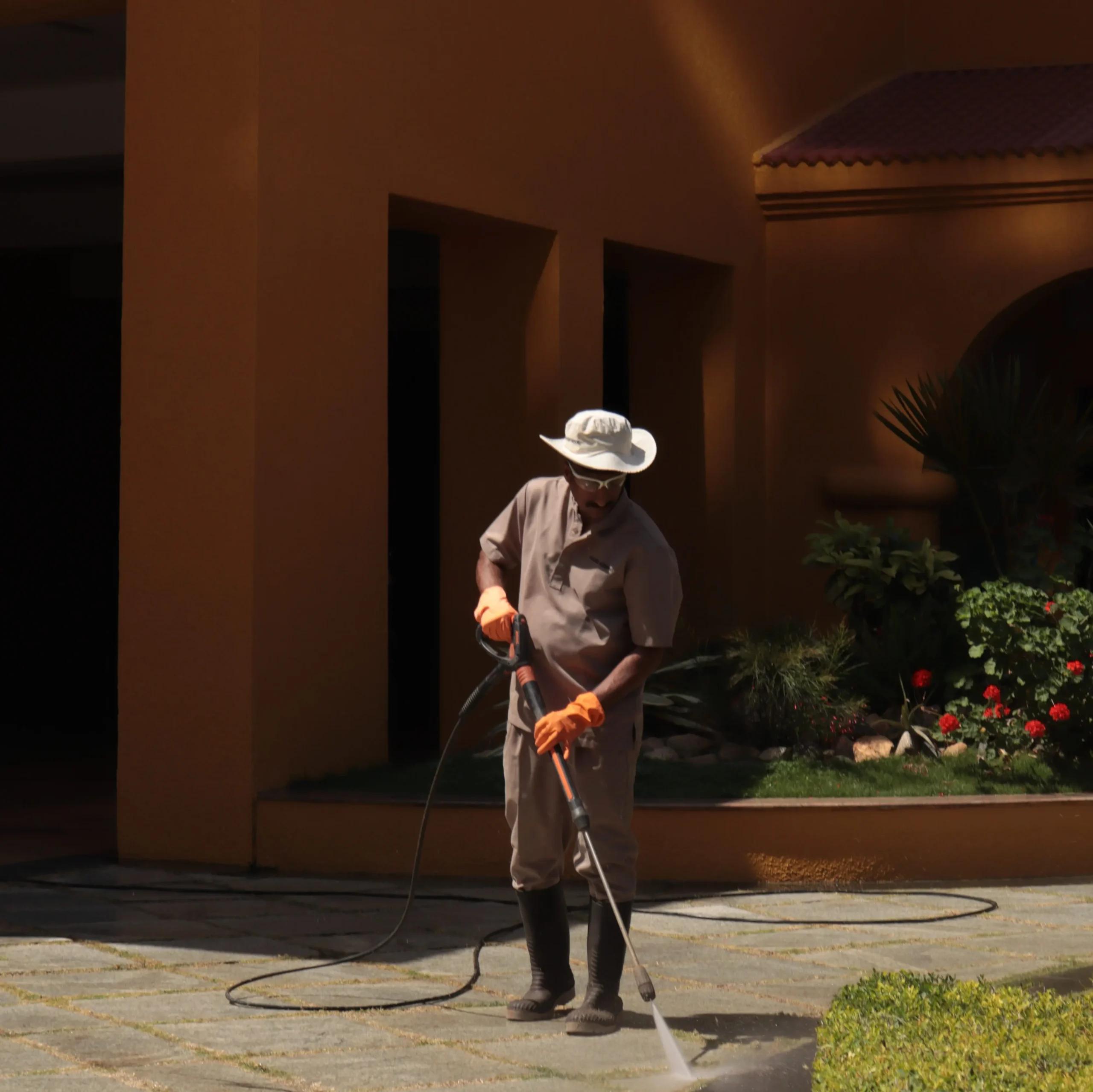 Professional high-pressure water blasting restoring a coastal property deck and driveway on Waiheke Island.